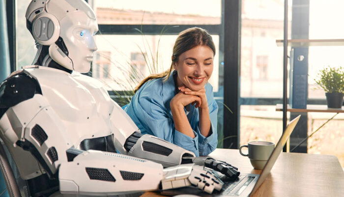 ridirobot-and-woman-working-on-laptop-in-office-2023-11-27-05-09-43-utc ridirobot-and-woman-working-on-laptop-in-office-2023-11-27-05-09-43-utc